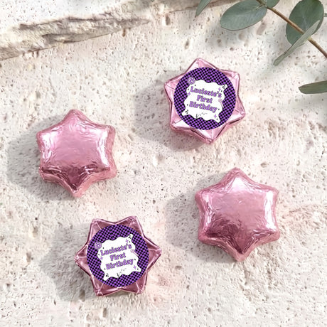Foil-covered chocolate star candies in pink and purple with personalised 'Birthday' topper