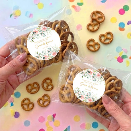 Personalised pretzel bag with floral pink round label and golden pretzels in clear wrap