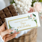 Birthday chocolate bar wrapper in white with gold border, florals, and '80th Birthday' text