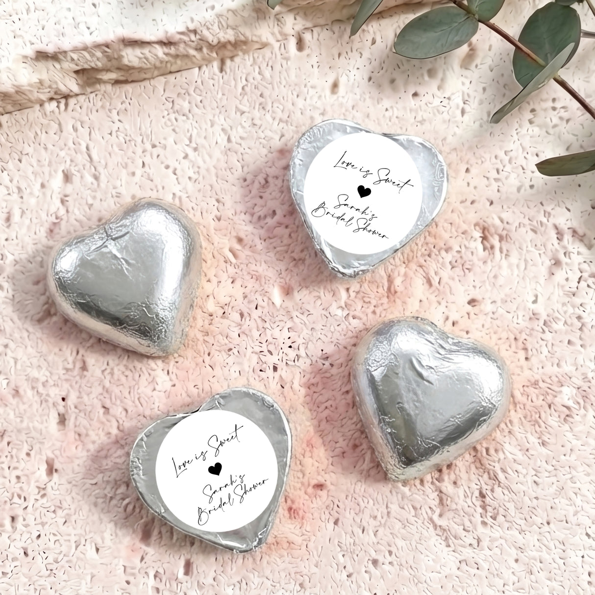 Silver heart foil-covered chocolates with white personalized label, Love is Sweet style
