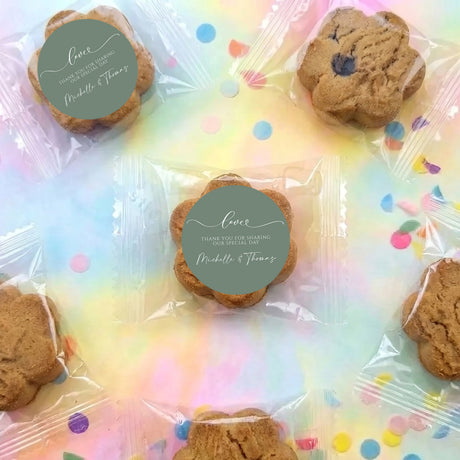 Chocolate chip cookie favors on clear bag with sage green round wedding labels