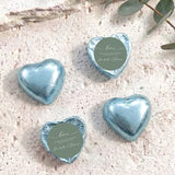 Light blue foil-covered heart chocolates with round personalized thank-you labels