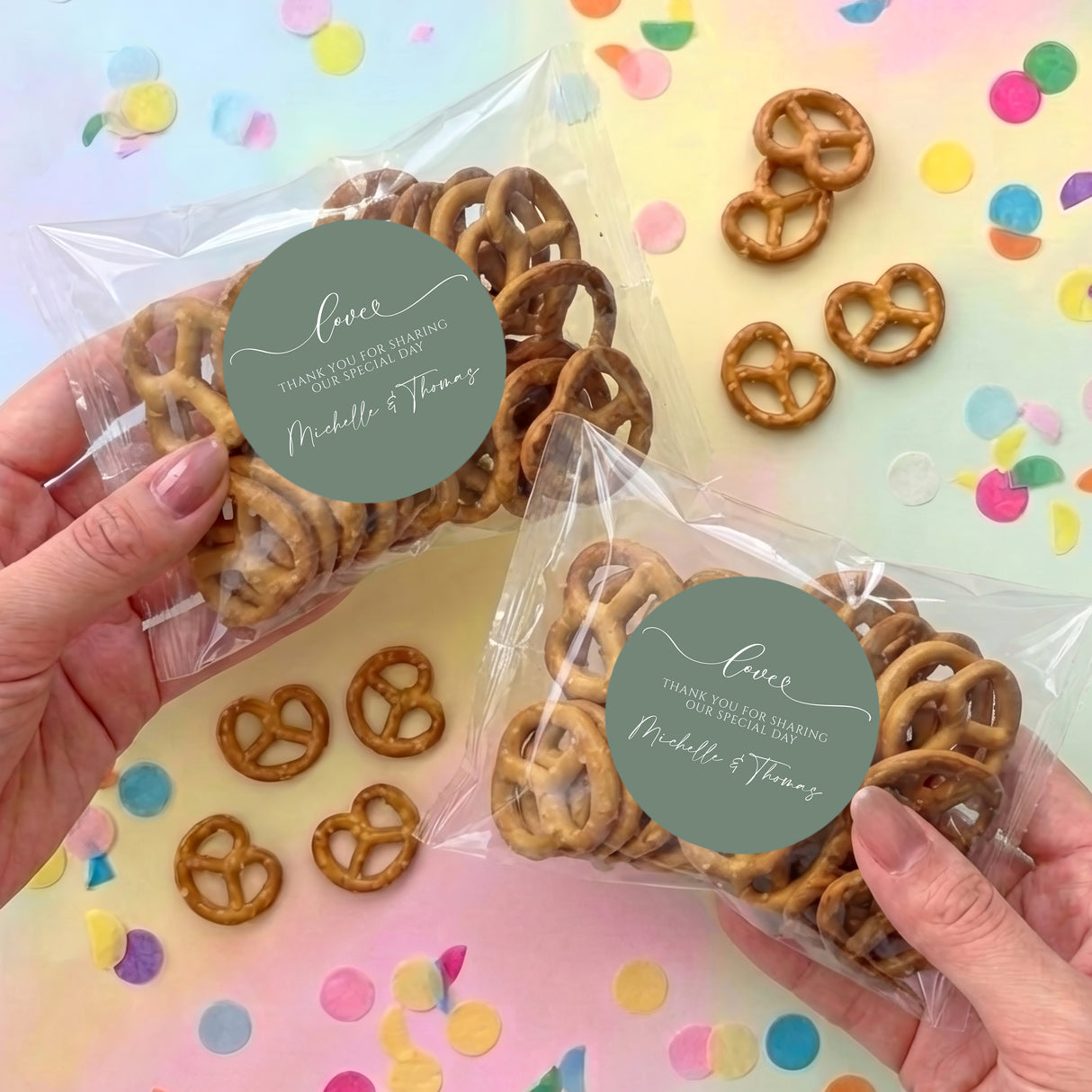 Personalized sage green wedding pretzel gift bags with pretzels and circular name labels