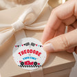 Round race car printed label with checkered flags and text “THEODORE is TWO FAST”