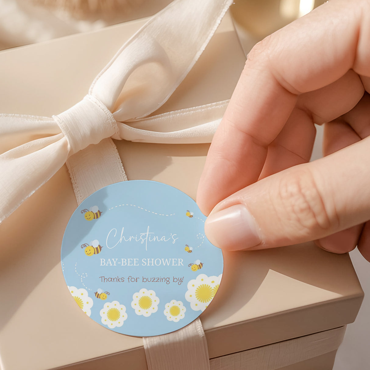 Round shower labels, light blue with bees and flowers; 'BABY-BEE SHOWER' text