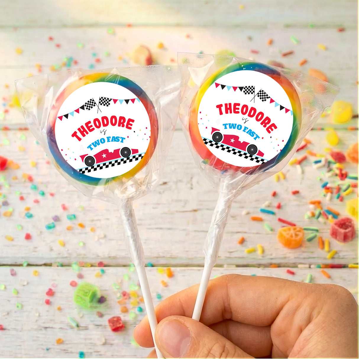 Personalised race car lollipops with rainbow-striped wrapper and printed car labels