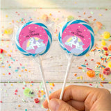 Two unicorn lollipops, 'Zara's 6th Birthday' pink labels with blue outer ring