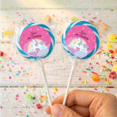 Two unicorn lollipops, 'Zara's 6th Birthday' pink labels with blue outer ring
