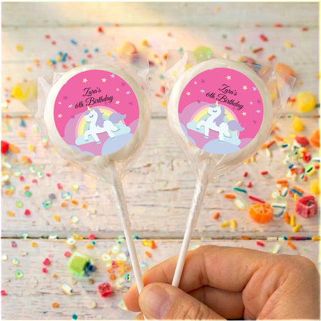 Two unicorn lollipops, 'Zara's 6th Birthday' pink labels with white outer ring