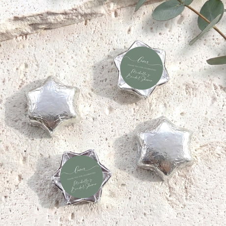 Foil-covered chocolate stars, silver with round personalized label