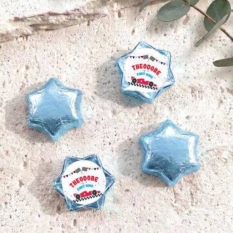Blue foil-covered chocolate star sweets with personalized "THEODORE" label