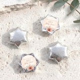 Foil-covered chocolate stars with silver metallic wrap and floral thank-you label