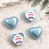 Light blue foil-covered chocolate heart with “THEODORE TWO FAST” label
