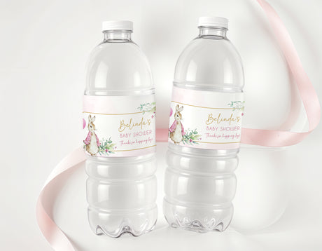 Two clear water/drink bottles with pink baby shower personalised labels and Peter Rabbit art
