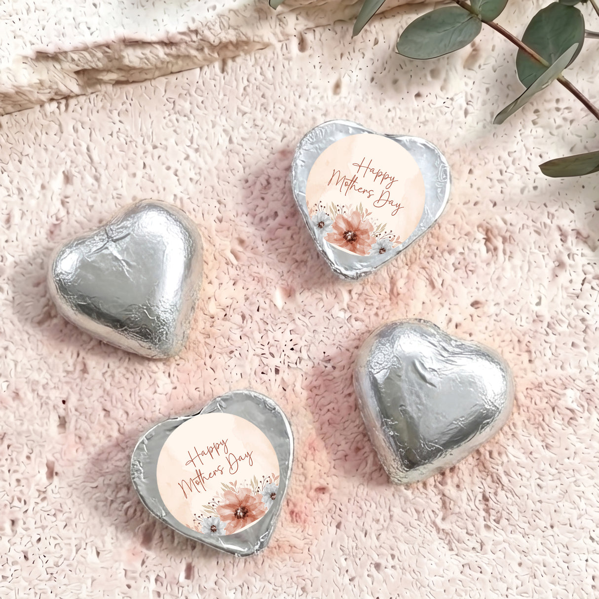 Silver heart-shaped foil chocolate with “Happy Mother’s Day” floral message on white center