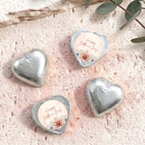 Silver heart-shaped foil chocolate with “Happy Mother’s Day” floral message on white center