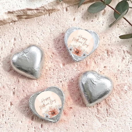 Silver heart-shaped foil chocolate with “Happy Mother’s Day” floral message on white center
