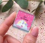 Hands holding a personalised unicorn rainbow mini chocolate for 60th birthday