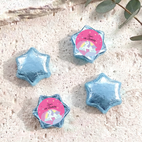 Blue star-shaped foil chocolate with “Zara’s 6th Birthday” unicorn rainbow label