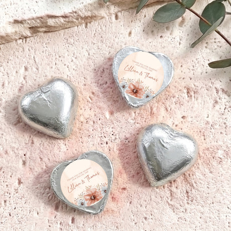 Silver foil-covered chocolate hearts with floral label and personalized “Lillian & Thomas”