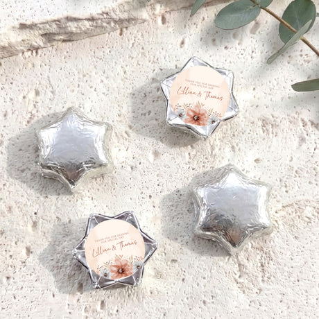 Personalised foil-covered chocolate stars with floral label, silver star-shaped chocolates