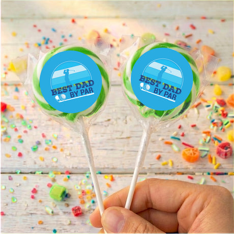 Personalised lollipops with blue 'Best Dad by Par' labels, clear wrap, held by hand