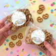 Personalised baptism pretzel bag with clear wrap and round safari animal label
