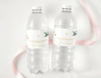Clear plastic water bottles with white personalized labels, gold cross and flower accents