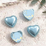 Blue foil-covered chocolate hearts with “Baby Bee Shower” gift card labels