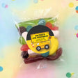 Personalised truck party lolly bag with mixed sweets and 'Archie's 4th Birthday' badge