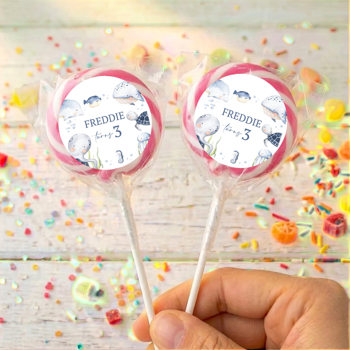 Personalised sea lollipops: two pink-bordered round wrappers with Freddie and age 3