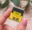 Personalised mini chocolate bar in foil with yellow truck birthday wrapper, held in hand