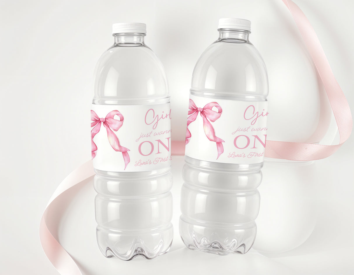 Set of two clear plastic water bottles with pink ribbon bows and printed birthday label