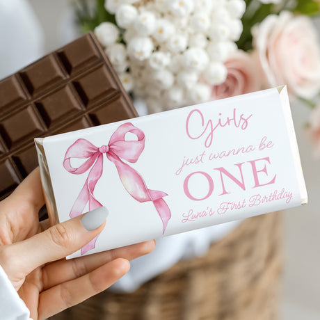 First birthday chocolate bar with pink bow and 'Girls just wanna be ONE' text