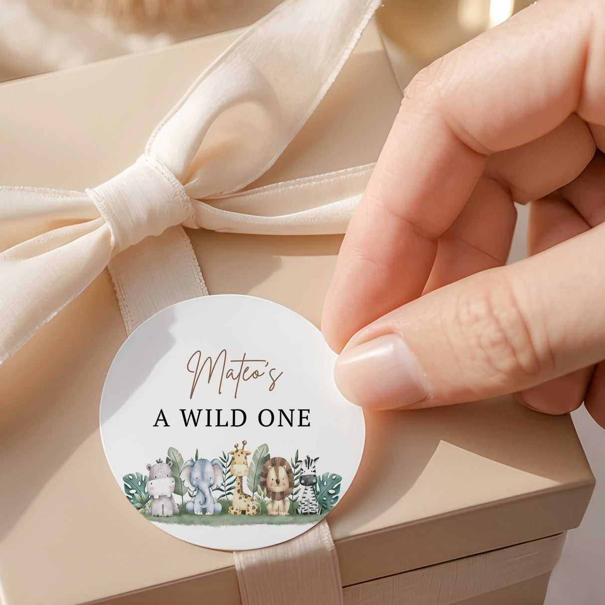 Wild One round label with “A WILD ONE” text and cute jungle animal graphic