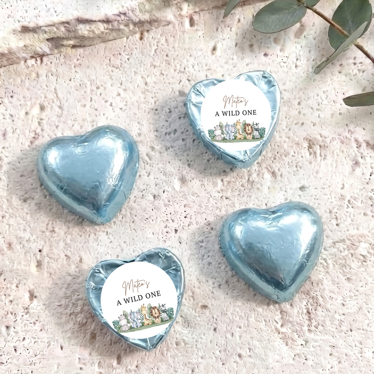 Light blue foil-covered chocolate hearts with white labels reading “A WILD ONE”.