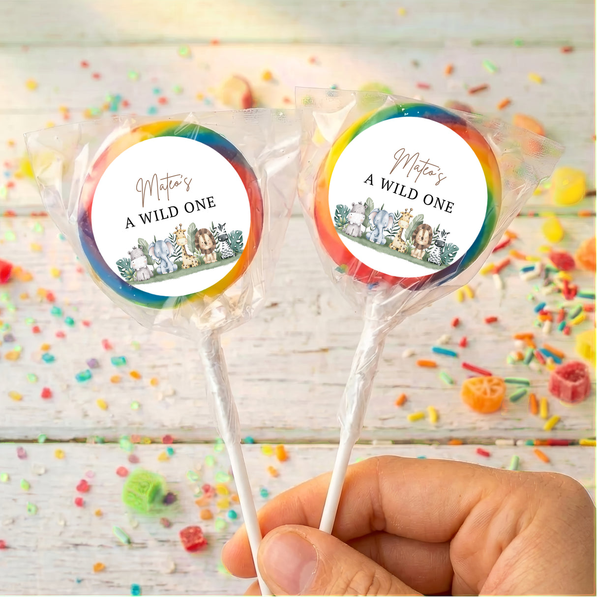 Personalised lollipop set, “A WILD ONE” labels with animal jungle graphics, rainbow ribbon
