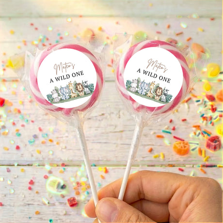 Personalised lollipop set, “A WILD ONE” labels with animal jungle graphics, pink ribbon