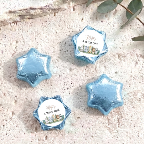 Blue foil-covered chocolate stars with round label reading “A WILD ONE”