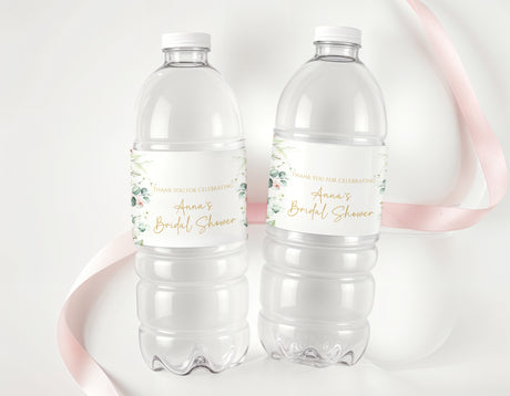 Personalised water bottle labels on clear plastic bottles with pink floral text