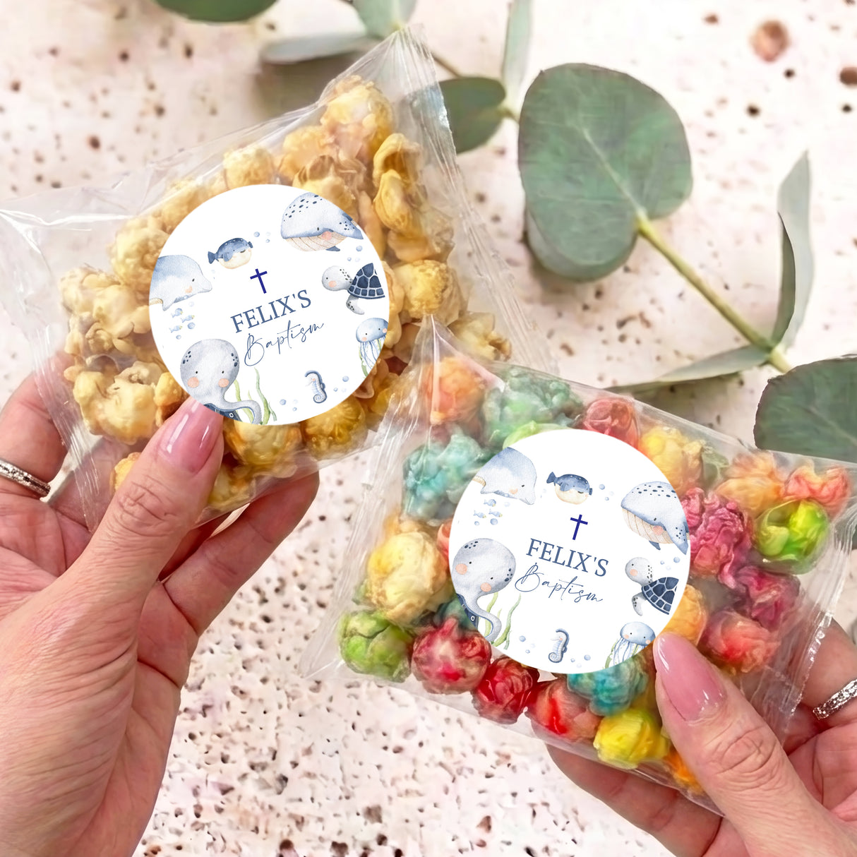 Personalised popcorn bag with round baptism label and sea-animal design, clear plastic wrap
