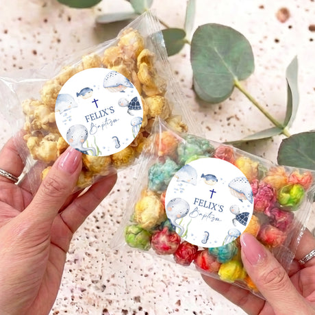 Personalised popcorn bag with round baptism label and sea-animal design, clear plastic wrap