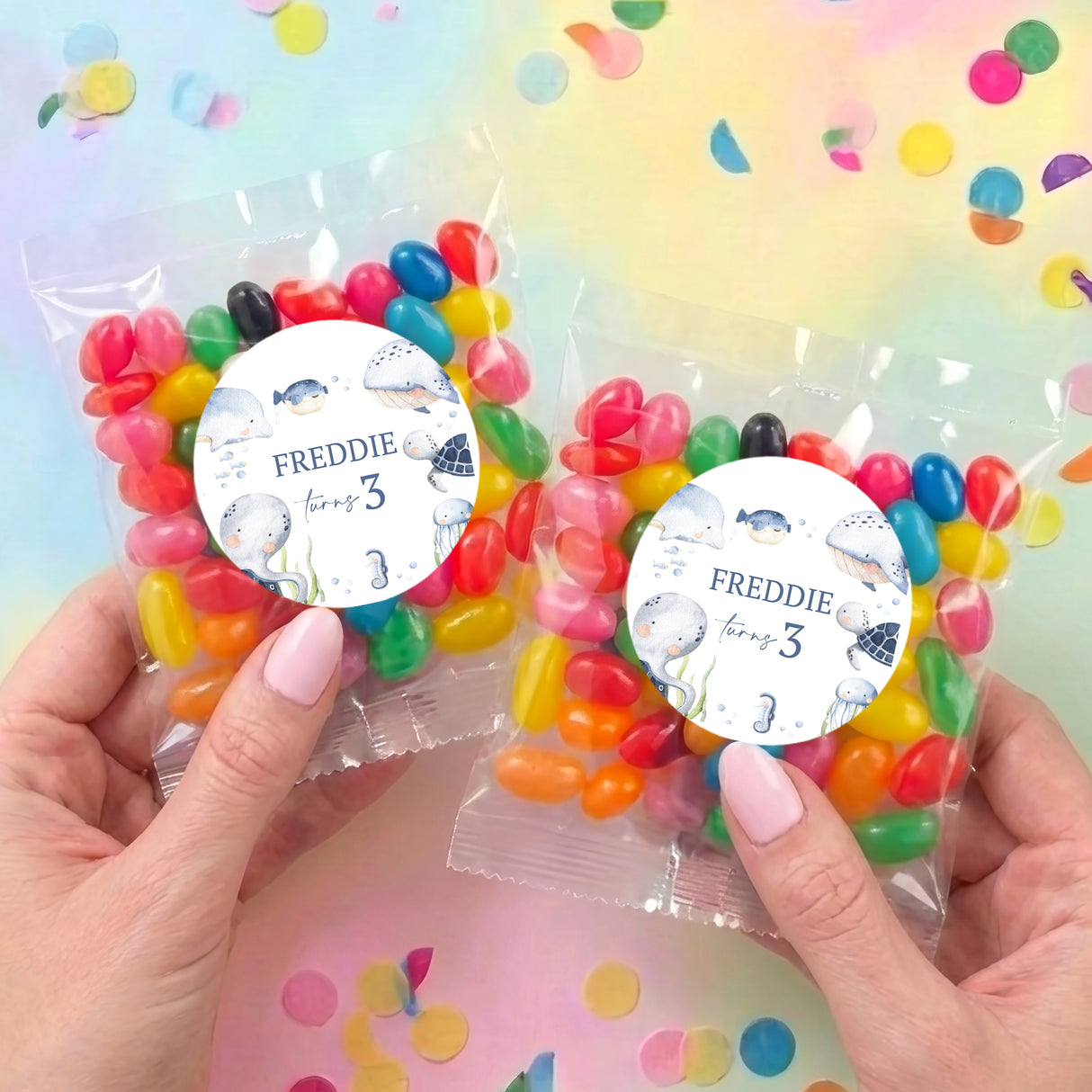 Two personalised jelly bean bags held, each with round sea-themed label: FREDDIE turns 3