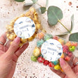 Personalised popcorn bag with clear pouch, colorful popcorn, and round blue Freddie label