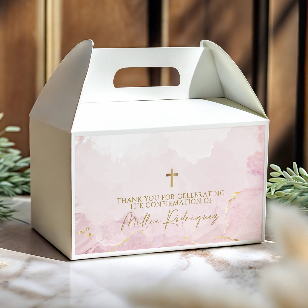 White gable favour box with window cutout, pink marble print, gold cross and thank-you text.