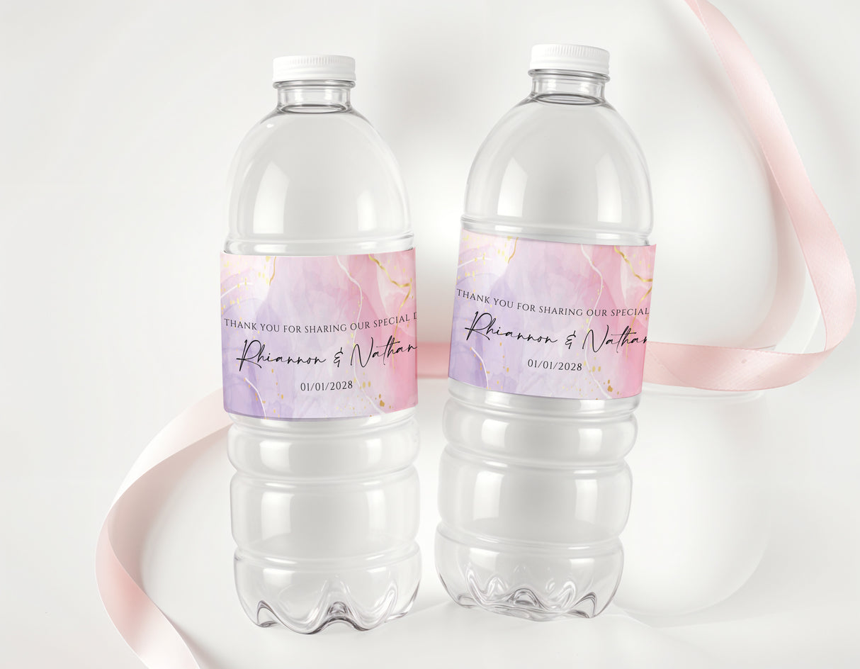 Personalised water bottle labels on clear bottles, pink-purple and gold text