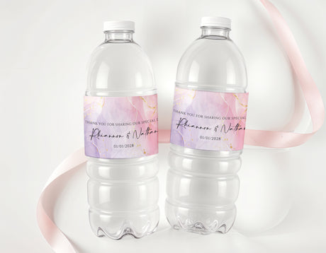 Personalised water bottle labels on clear bottles, pink-purple and gold text