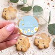 Personalised bite-size choc chip cookies with blue 'Dolly's First Birthday' label