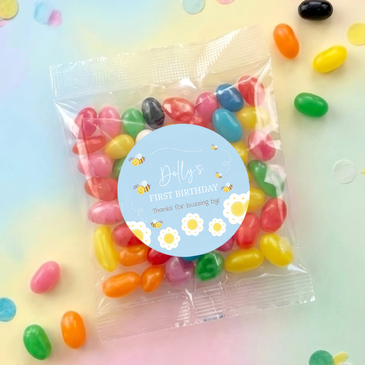 Personalised jelly bean party bags with blue round label and colorful candies inside