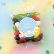 Personalised first birthday lolly bag with blue bee label and mixed wrapped sweets
